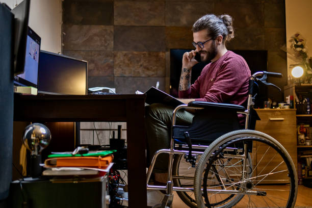 istock Man in wheelchair at home 1283071818