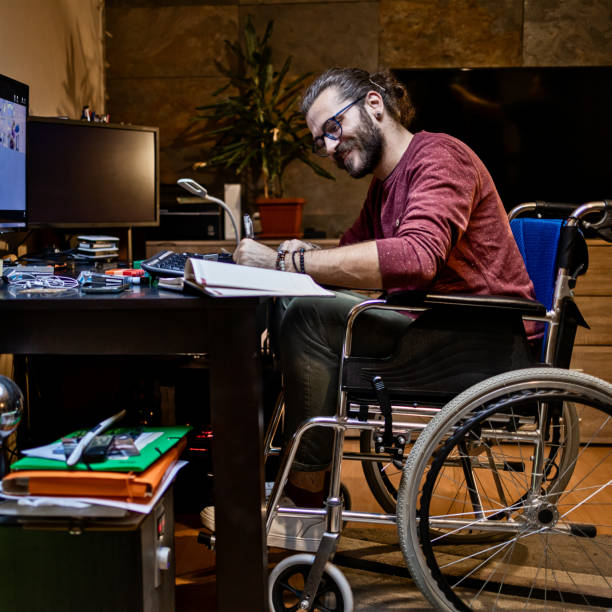 istock Man in wheelchair at home 1283071861
