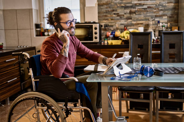 istock Man in wheelchair at home 1283071940