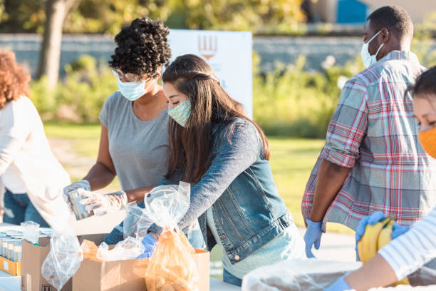 istock Multi-ethnic group of people sort food for distribution 1283071997