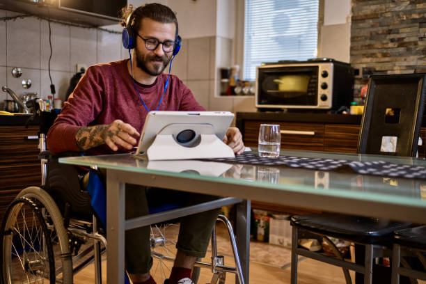 istock Man in wheelchair at home 1283072056