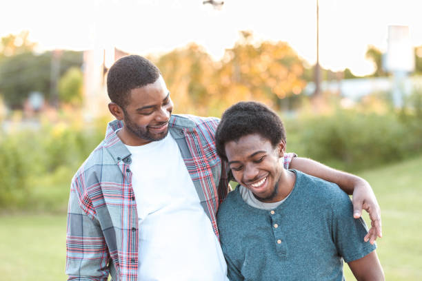 istock Happy father and son walking in a park 1283072152