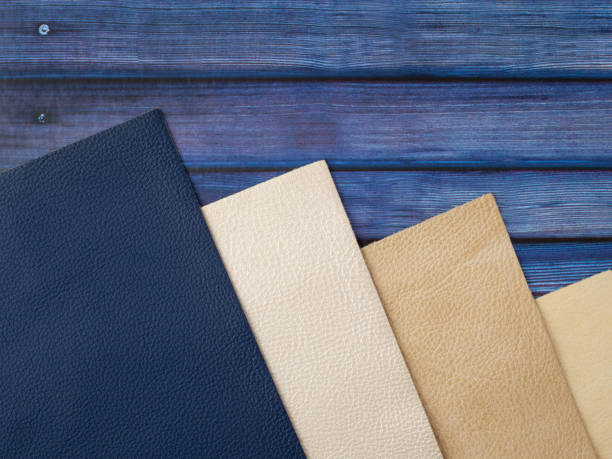 Natural leather textures samples on blue wooden background Different colors natural leather textures samples on blue wooden background leather white hide textured stock pictures, royalty-free photos & images