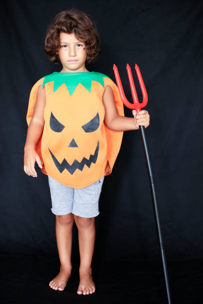 istock Cute kid in halloween costume scaring pose. 1283073410