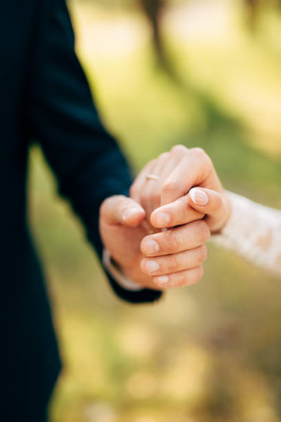 istock hands of groom and bride hold together 1283074151