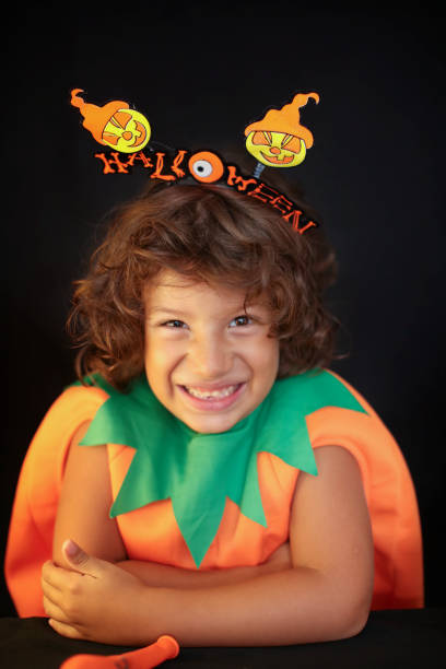 istock Cute kid in halloween costume scaring pose. 1283074201