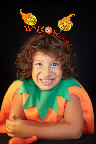 istock Cute kid in halloween costume scaring pose. 1283075312