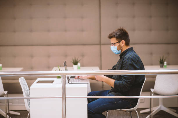 istock Man working in  office with his protective face mask during the COVID-19 pandemic 1283075769