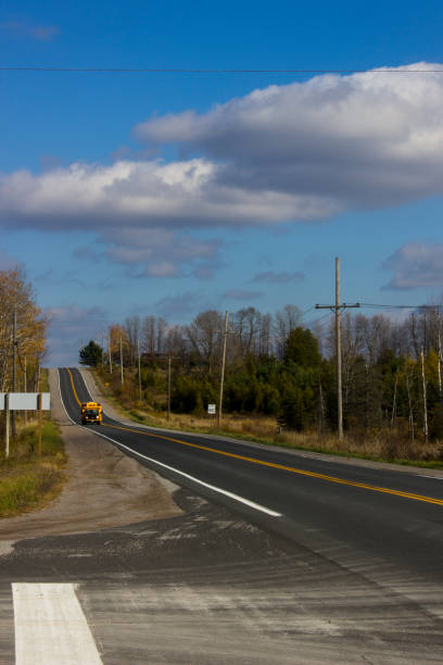 istock School Bus Driving Down Country Highway 1283076197