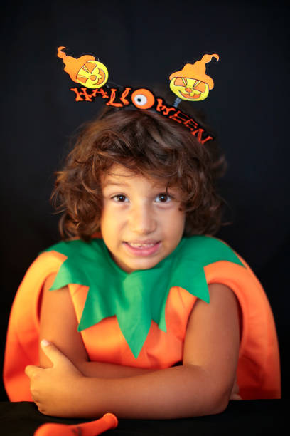 istock Cute kid in halloween costume scaring pose. 1283076322
