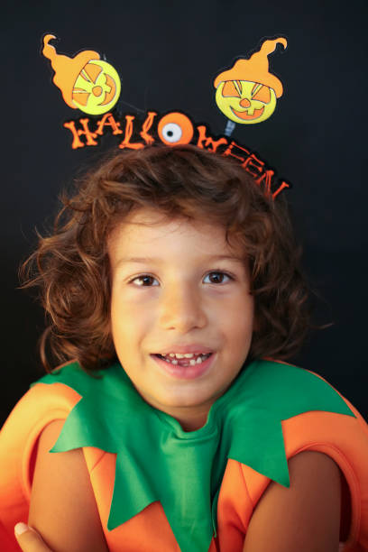 istock Cute kid in halloween costume scaring pose. 1283077361