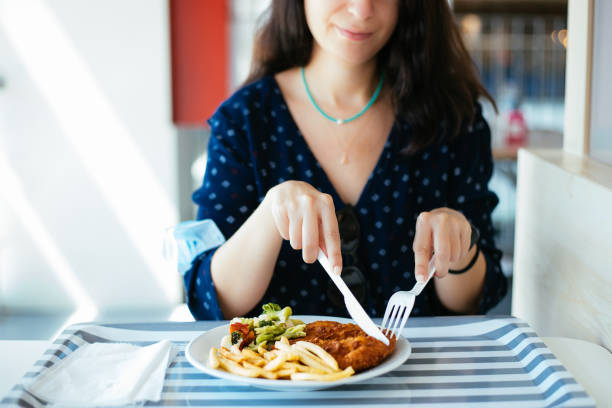 istock Woman with protective face mask holding serving tray, having lunch at cafeteria 1283077715