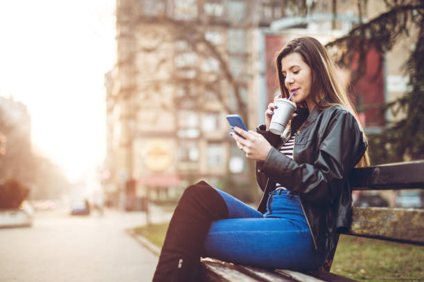 istock Woman checking social media on bench 1283079273