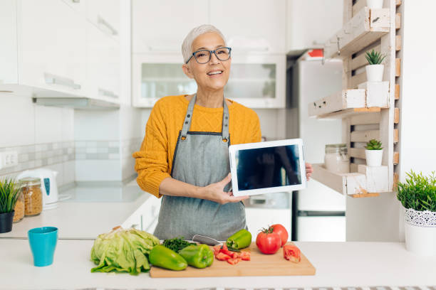 istock Happy mature vegan podcasting at her kitchen 1283079656