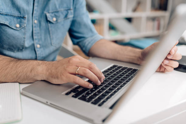 istock Unrecognizable businessman working on laptop 1283080656