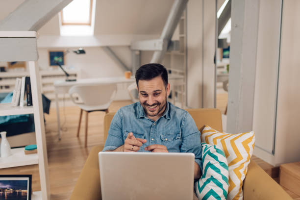 istock Businessman having a web conference from his living room 1283080735