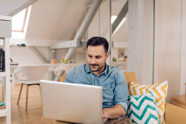 istock Young freelancer enjoying working from the living room 1283080741