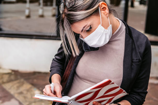 Woman taking notes outdoors