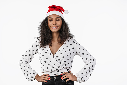 Portrait of happy african american woman in santa claus hat isolated on white