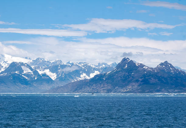 Mountains of Alaska The mountains of the Prince William Sound offer stunning views for the tourists. Ice bergs floating in the sound adds to the stunning view. Alaska, a land of snow and ice was on full display. Snow can be seen upon the mountains throughout the year. prince william sound photos stock pictures, royalty-free photos & images