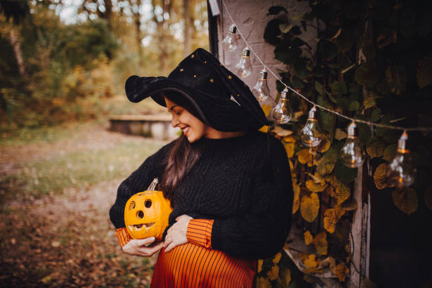 istock Smiling Woman Holding Jack o' Lantern 1283087730