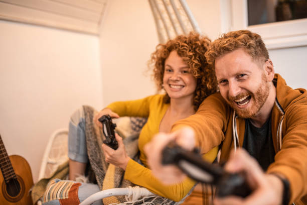 istock Happy couple playing video games. 1283089283