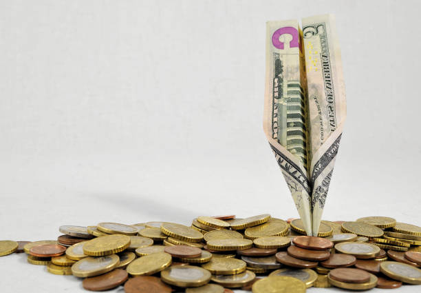 istock Flying Money Concept a Dollar Airplane 1283089320