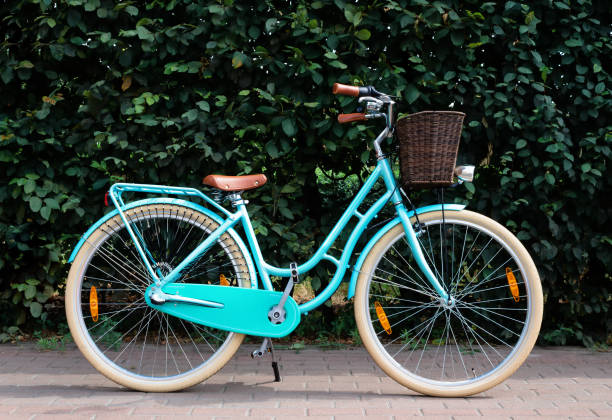 istock Female retro bicycle with basket on green foliage background. 1283089698