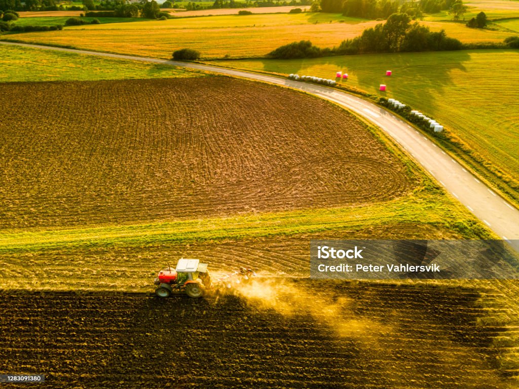 Agricultural work Tractor on a field thats look like art, harvesting, air photography Sweden Stock Photo