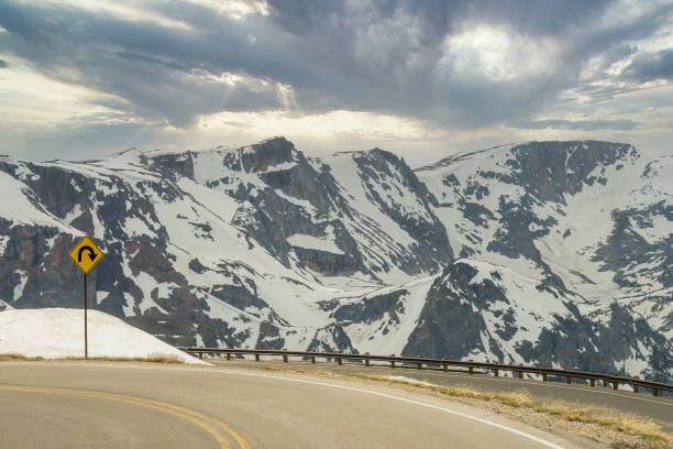 istock Road through the snow capped mountain 1283091432