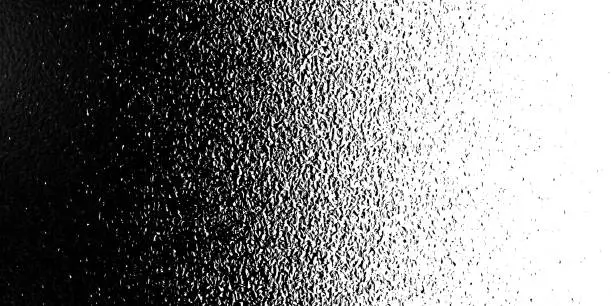 Photo of Black on white background. Black and white dissolve in half in each other. Silky rough textured black matter mixed with white. Looks like halftone of mix grunge. Art Illustration