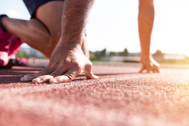 istock Runner using starting block to start his run on race track. 1283091651