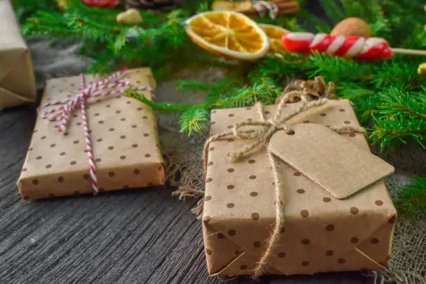 Photo of A bunch of Christmas boxes are lying on a wooden table.