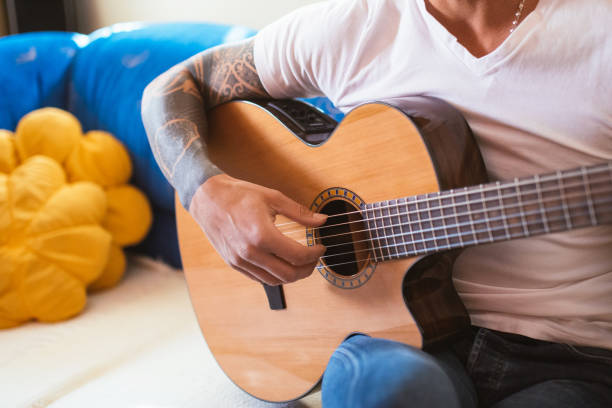 istock Man playing acoustic guitar on a video call 1283094086