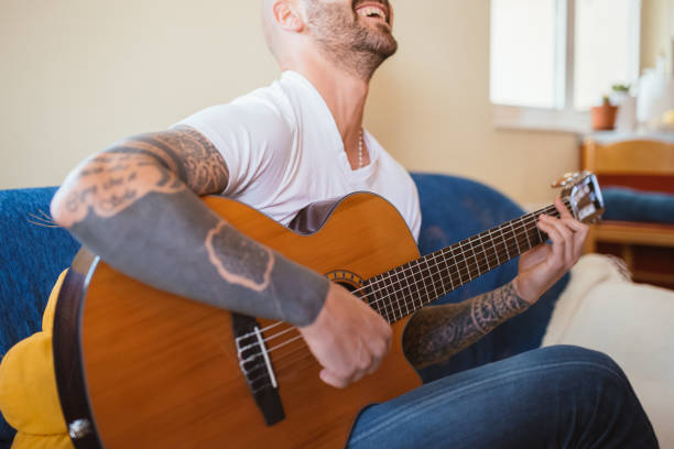 istock Man playing acoustic guitar on a video call 1283094134