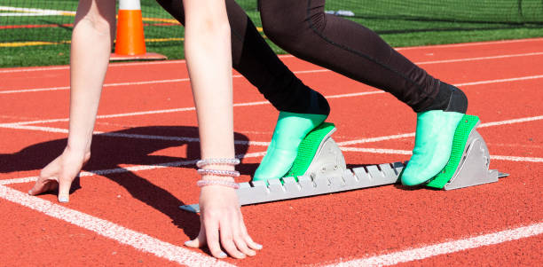 istock Arms and legs of sprinter in starting blocks 1283094324
