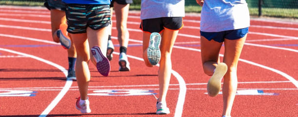 istock Group of runners legs together on a track 1283094374