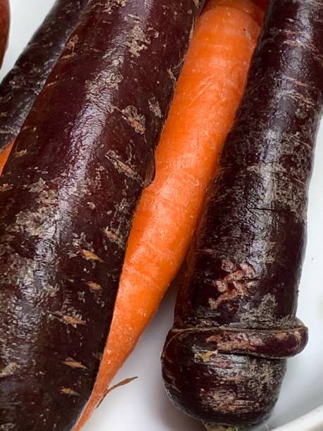 istock yellow carrots, purple carrots, close up 1283095647