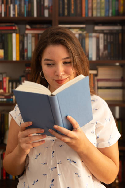istock Young woman holding book in her hands 1283096590