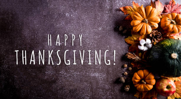 istock Thanksgiving background decor from dry leaves and pumpkin on dark stone  background. Flat lay, top view with copy space 1283096597