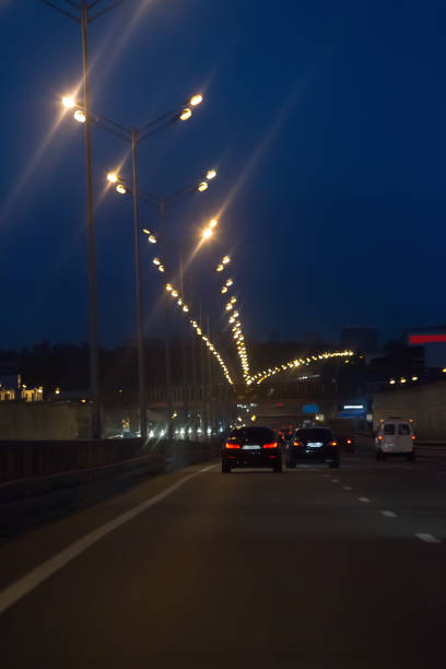 istock Car traffic at night on the avenue 1283097363