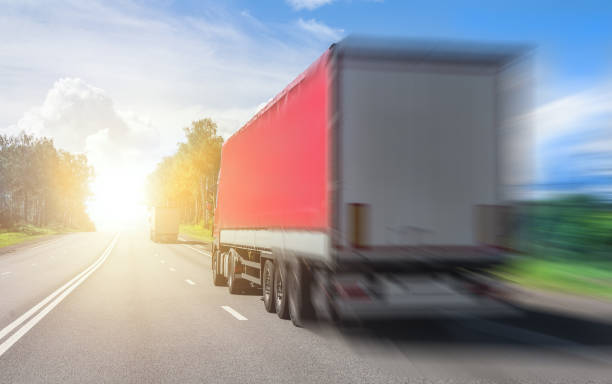 istock Trucks carry goods on a highway 1283097384