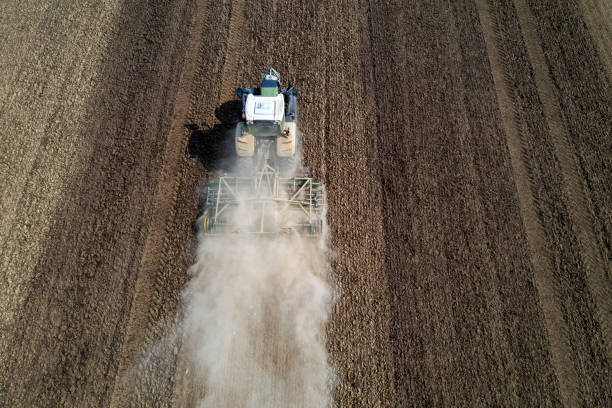istock Tractor with harrow on field, aerial view 1283098997