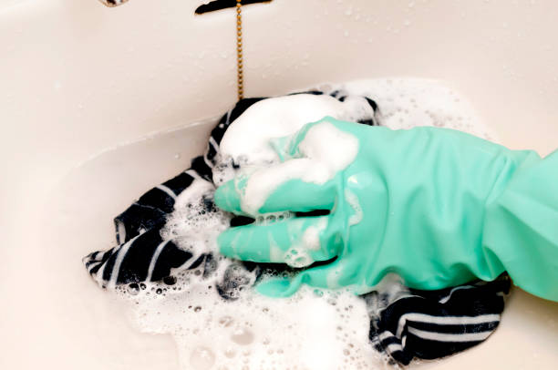 istock hand in a rubber glove washes clothing 1283099013