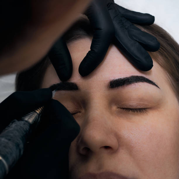 istock Permanent eyebrow makeup procedure. Eyebrow tattooing, process. The use of tools by a master for permanent eyebrow makeup. 1283099440