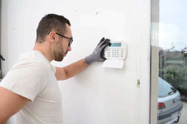 istock handsome man worker installing alarm technology insurance in home for burglar prevention 1283100328