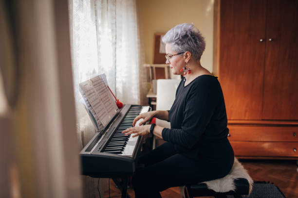 istock Young woman playing synthesizer at home 1283100436
