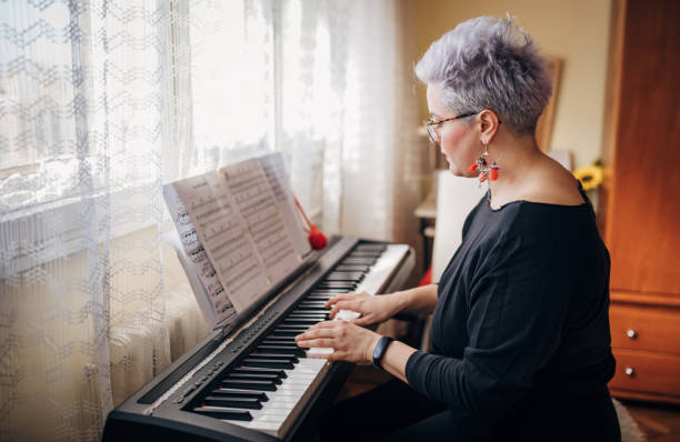 istock Woman playing synthesizer in her living room 1283100461
