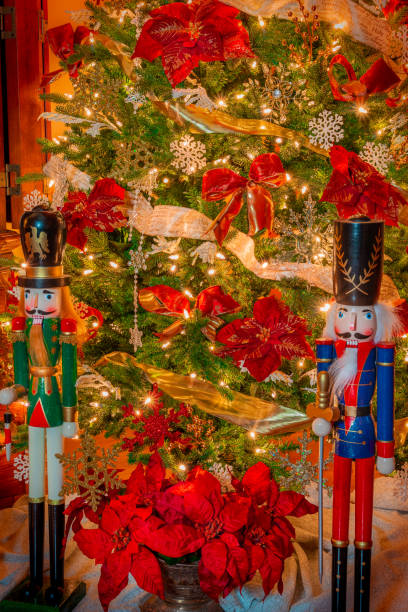 istock Two large nutcrackers stand on  guard in front of  a  decorated Christmas tree . 1283106109