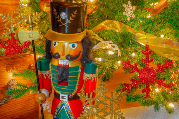 istock A nutcracker stands on  guard in front of  a  decorated Christmas tree . 1283106124
